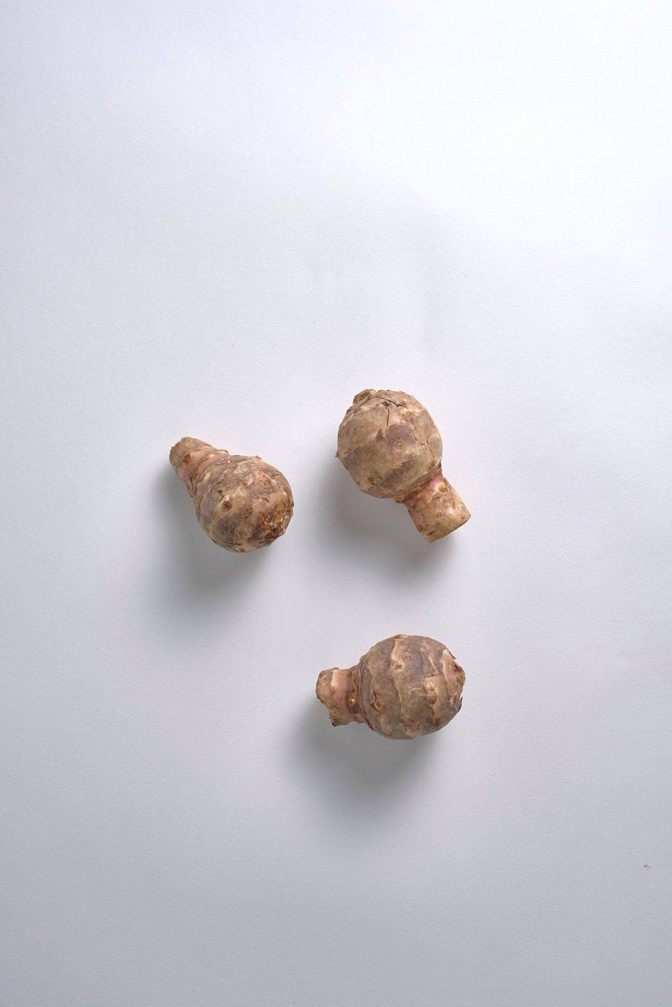 jerusalem-artichokes three jerusalem artichokes with white background