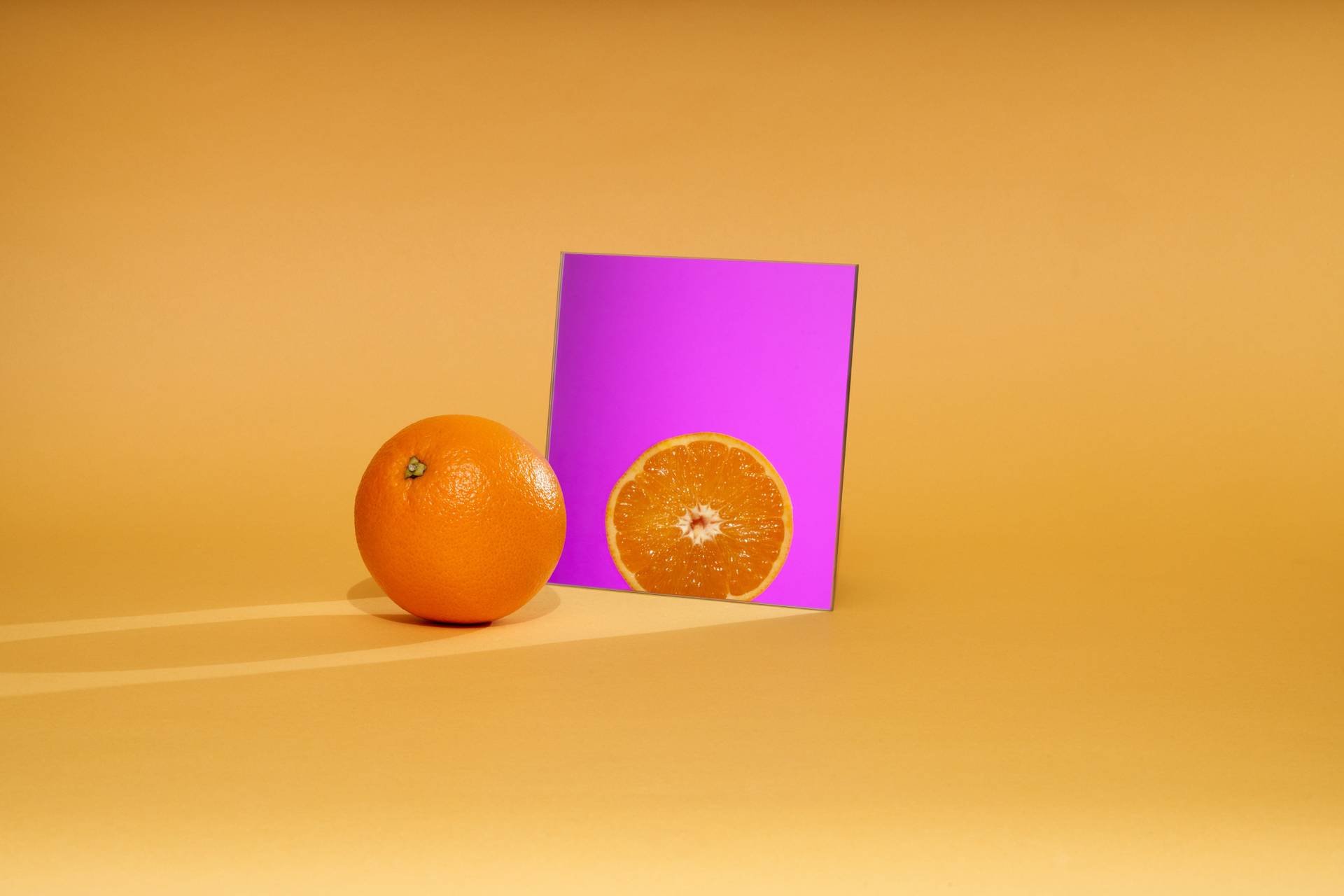 orange orange with purple mirror on yellow background