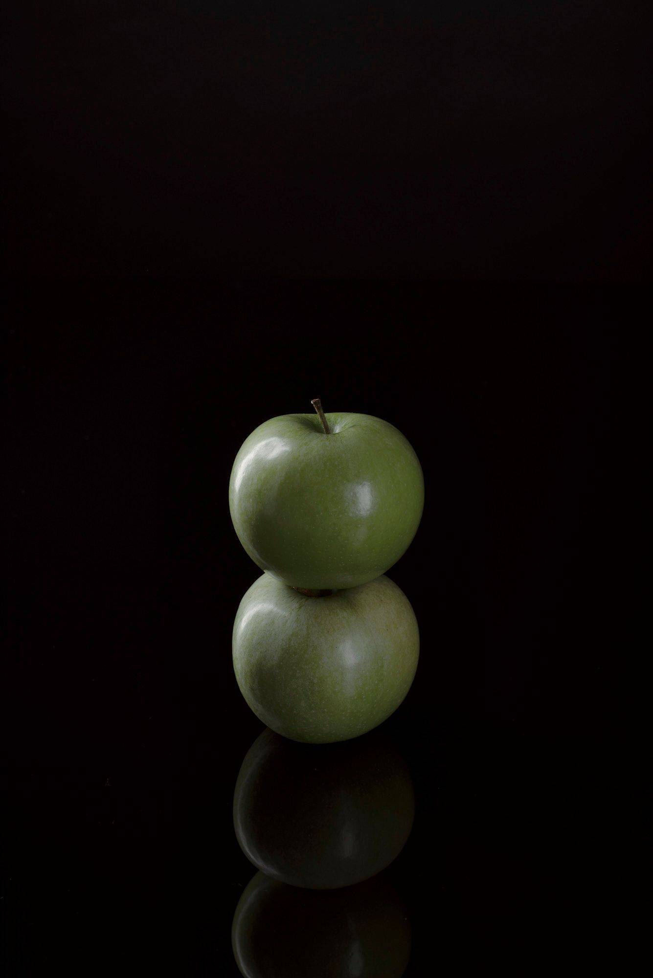 green-apples two green apples with black background