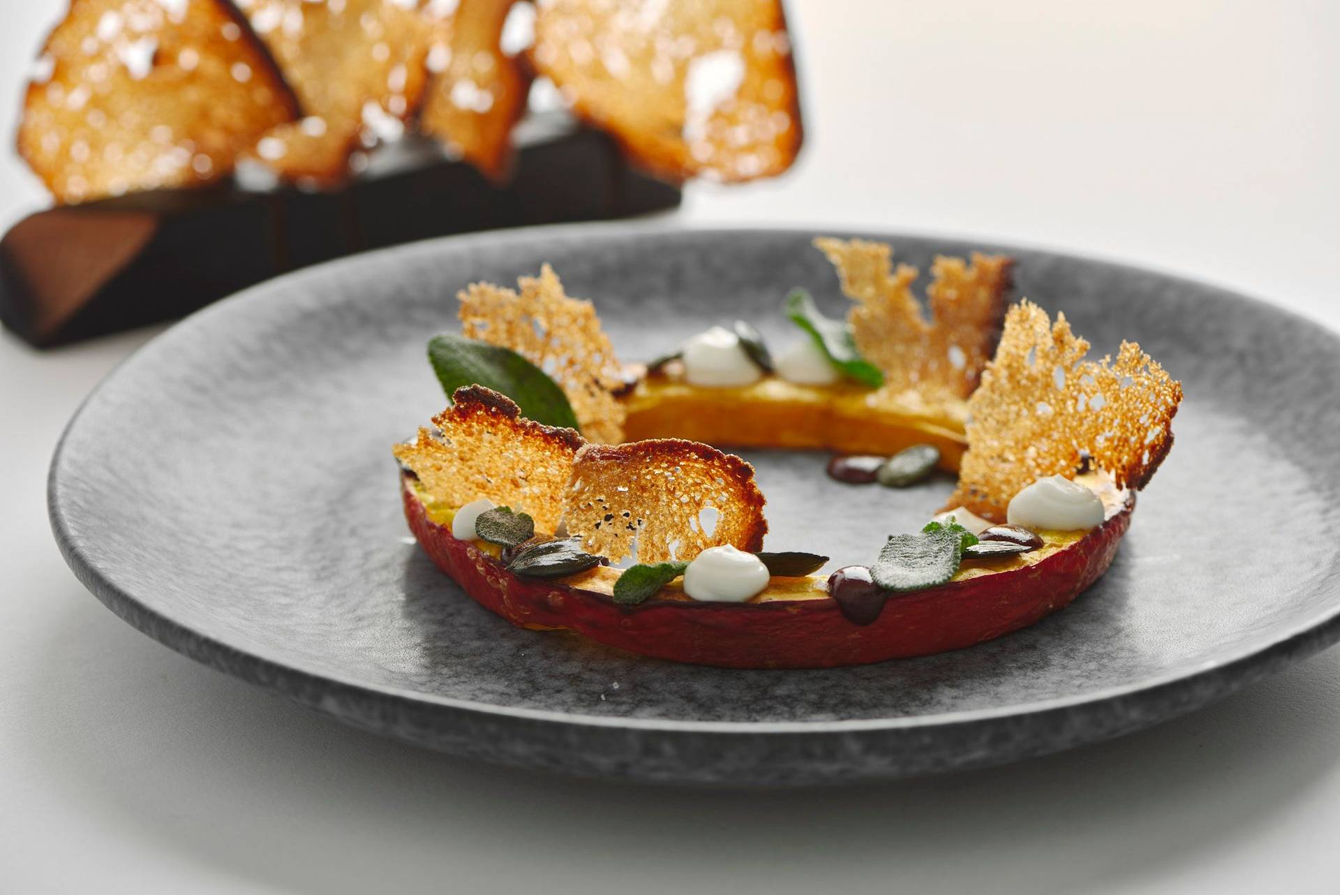 pumpkin-variation-with-sage-and-sourdough-bread pumpkin variation with sage and sourdough bread on a gray plate with white background